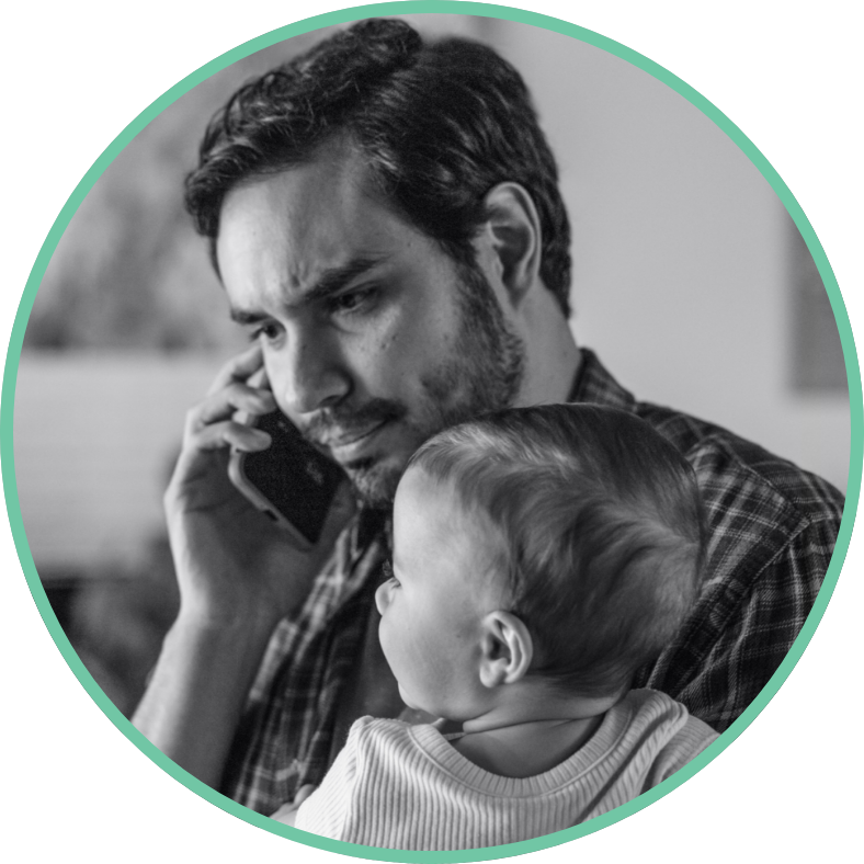 Parent on phone while holding baby 